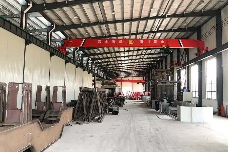 Automated production line manufacturing container spreaders